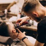 Professional barber maintaining a clean fade haircut in Surrey barbershop