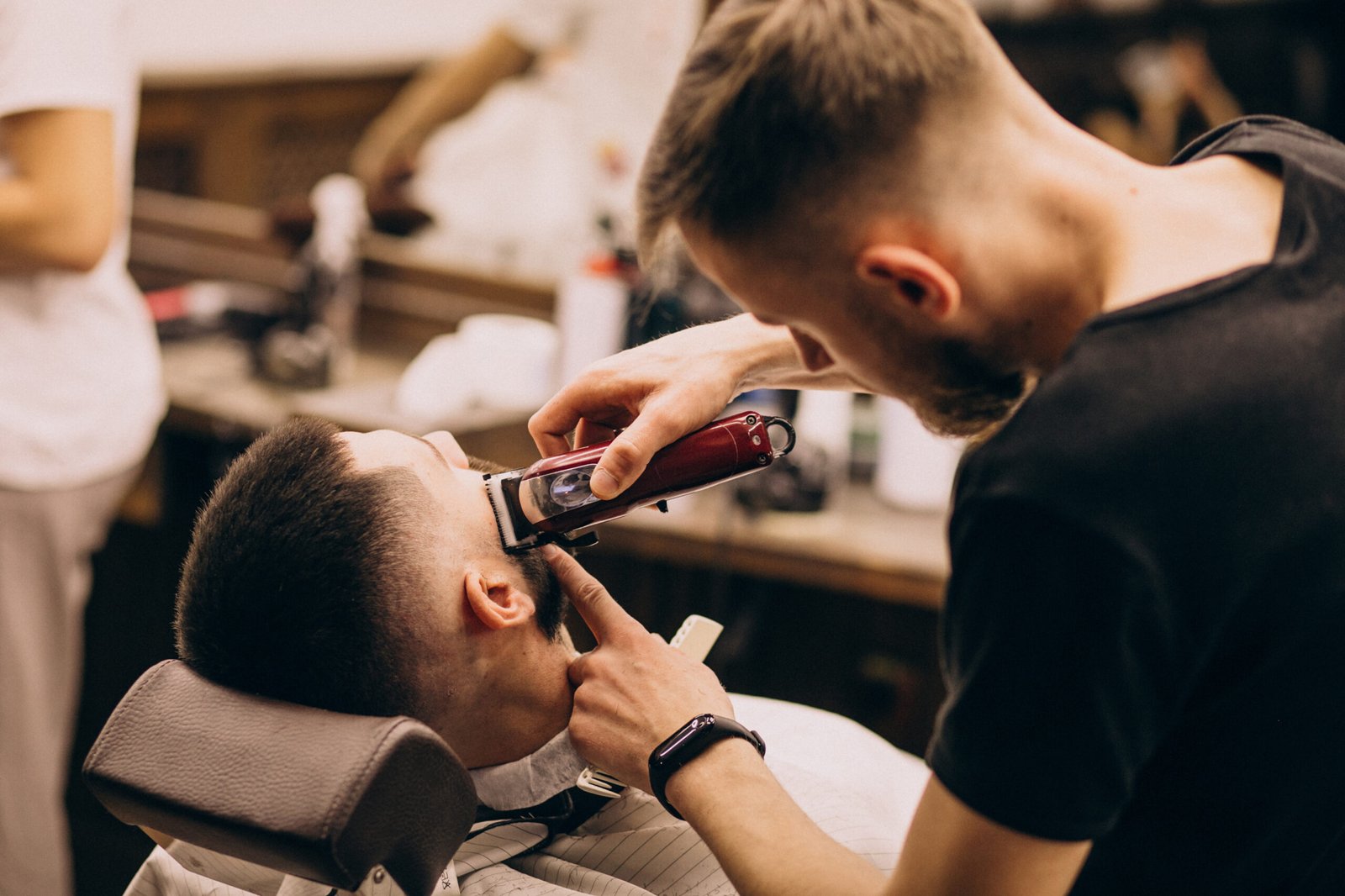 Professional barber maintaining a clean fade haircut in Surrey barbershop